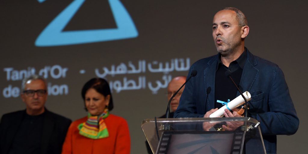 Moroccan director Mohamed Mouftakir delivers a speech after receiving the Golden Tanit award for his film "L'orchestre des aveugles" during the closing ceremony of the 26th Carthage Film Festival on November 28, 2015 in the Tunisian capital Tunis. AFP PHOTO / FETHI BELAID / AFP / FETHI BELAID